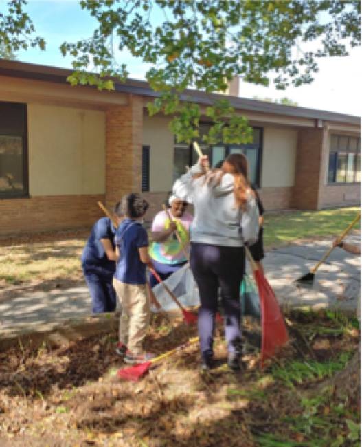 students raking at Shawmut Hills sycamore circle mural site